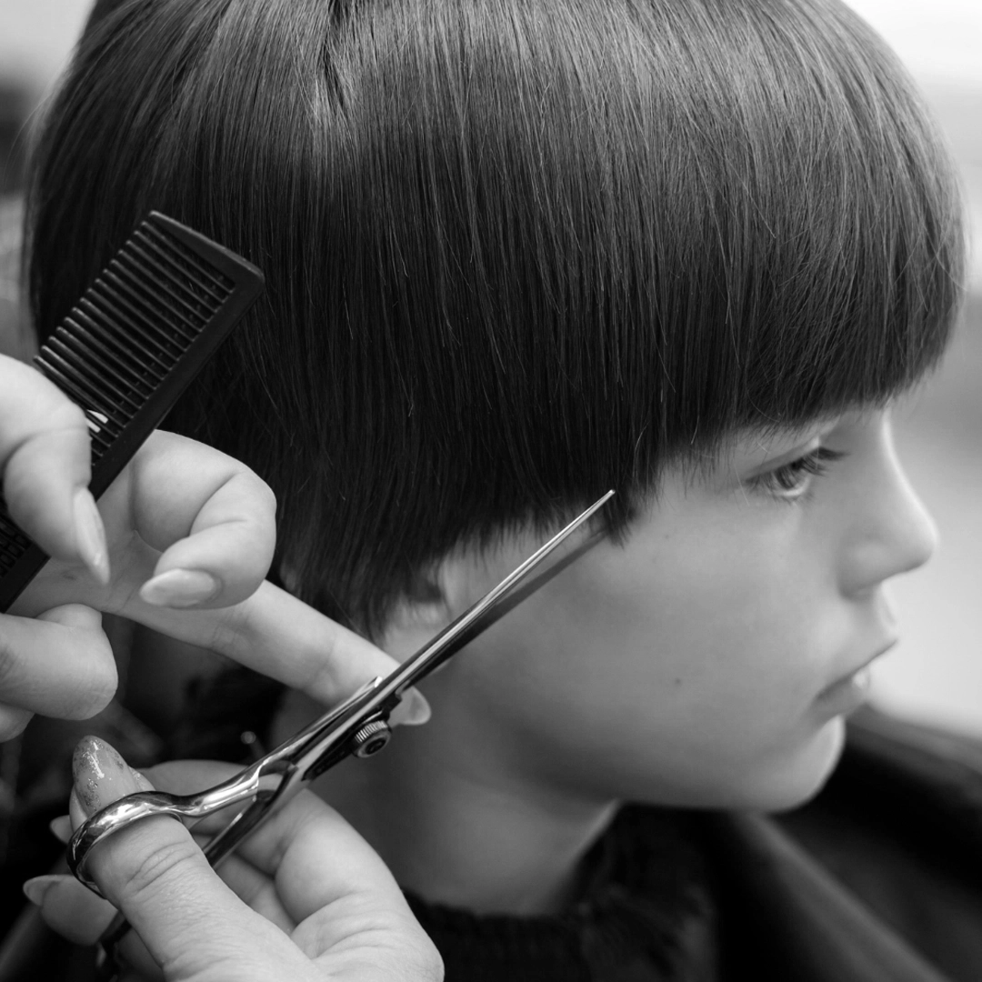 Barber working carefully with a client in the chair