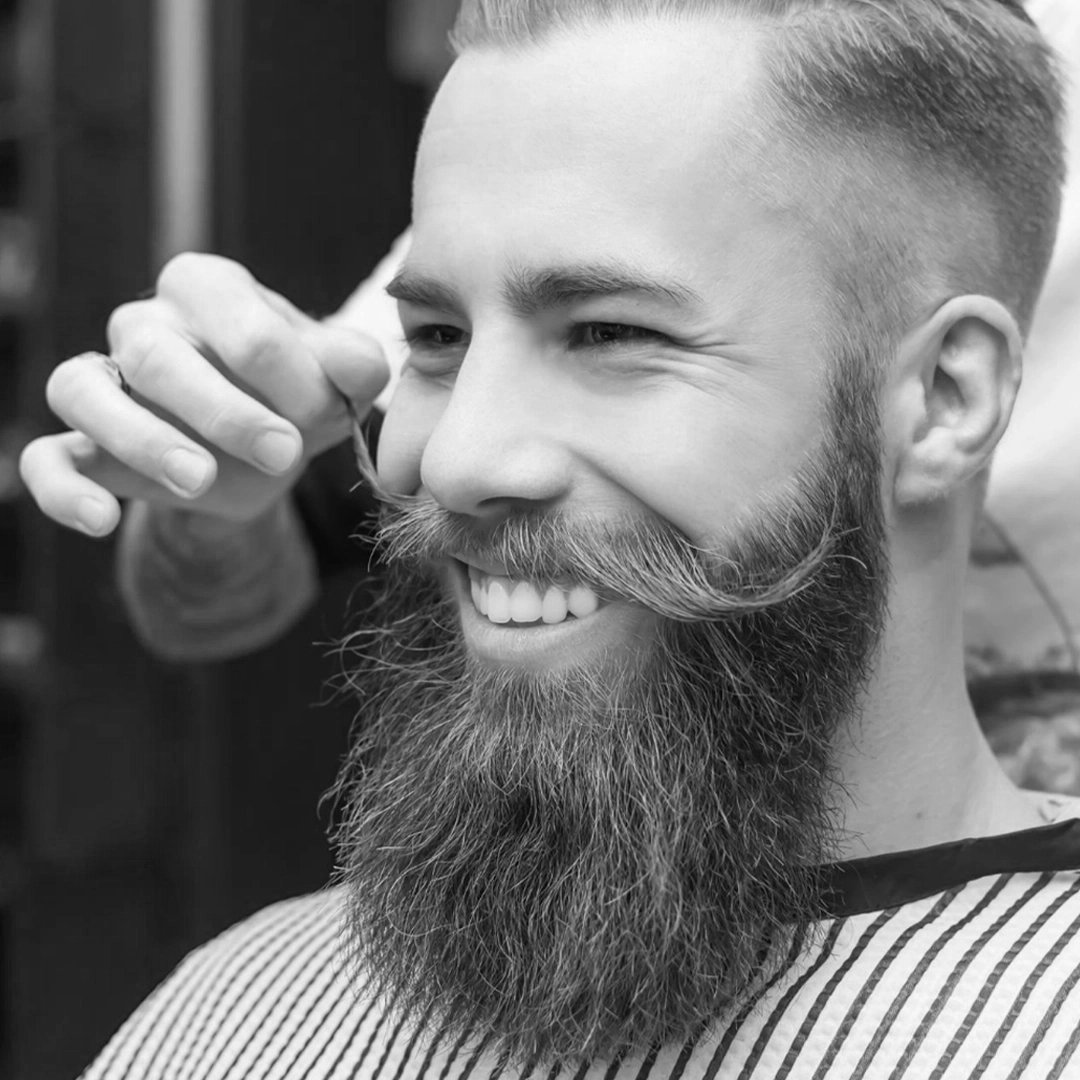 Barber using scissors and a comb during a haircut